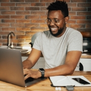 man typing on laptop