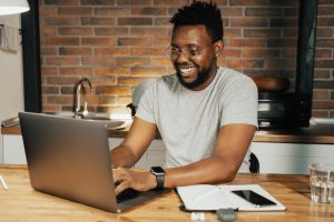 man typing on laptop